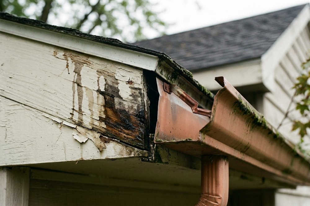 Storm-damaged gutter being repaired on an east-side home